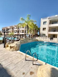 a swimming pool in front of a building at Royal Seacrest new apartment B G2 ground floor in Paphos