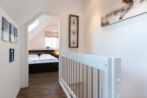 a hallway with a staircase leading to a bedroom at FeWo Lilly & FeWo Max in Westerland (Sylt)