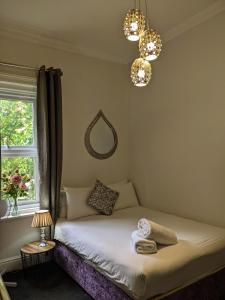 a bedroom with a bed with a window and a mirror at Blue Keys Hotel Southampton in Southampton
