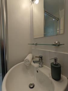 a bathroom with a white sink and a mirror at Blue Keys Hotel Southampton in Southampton
