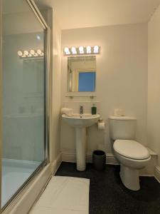 a bathroom with a toilet and a sink and a shower at Blue Keys Hotel Southampton in Southampton