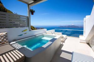 a swimming pool on a balcony with a view of the ocean at Caldera's Majesty in Imerovigli