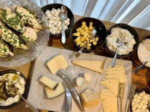 a table topped with plates of cheese and other appetizers at Jo Shtibel Tel-Aviv in Tel Aviv