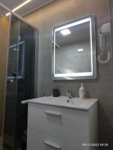 a bathroom with a sink and a mirror at Cozy loft at Teleferic in Sinaia