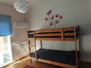 a bunk bed in a room with a flower on the wall at SAILORS LUXURY APPARTMENT 130m2 in Athens
