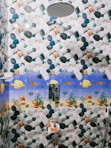 a room with a wall covered in white and black shells at Achayans Homestay Mararikulam in Mararikulam +61 photos