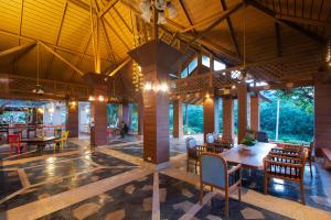 a restaurant with tables and chairs in a building at ปานเทล เขาใหญ่ Parntel KhaoYai in Khao Yai