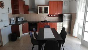a kitchen with a table and chairs in it at Apartment Marta in Rab