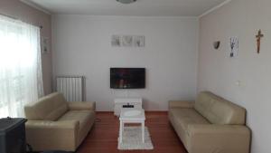 a living room with two couches and a tv at Apartment Marta in Rab +3 photos