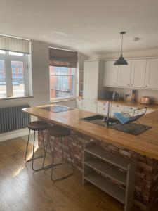 a kitchen with a wooden counter top in a room at Upstairs river apartment in Gloucester