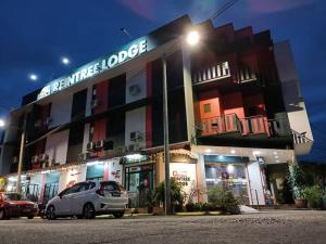 a car parked in front of a building at night at Reintree Lodge Hotel in Ipoh