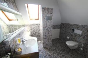 La salle de bains est pourvue d'un lavabo et de toilettes. dans l'établissement Abasto Hotel Eichenau, à Eichenau