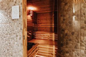 a wooden sauna in a room with a wall at Orava Village in Oravská Lesná