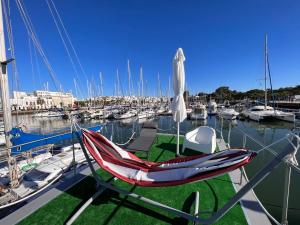 a chair sitting on a boat in a marina at Casas Flotantes - Boatvillage in Ayamonte