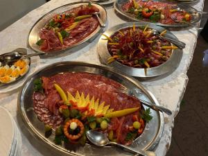 a table with many different plates of food on it at Rooms Balkovec in Dragatuš