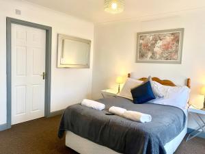 a bedroom with a bed with two towels on it at Fabrik Apartments - Harrowside by Blackpool Service Apartements in Blackpool