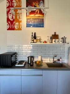 a kitchen counter with a sink and a microwave at HAWAII in Eilat