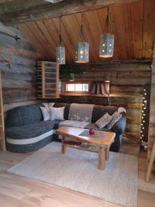 a living room with a couch and a coffee table at Rukan Kelostar in Kuusamo