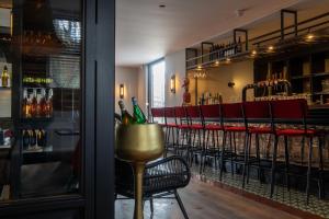 a bar with a bunch of chairs in a room at Boutique Hotel Four in Geldrop