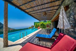 a villa with a swimming pool and a patio at 2 Bedroom Private Villa with great sea view in Faralya