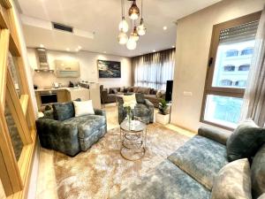 a living room with couches and a table at Nice 11 - Spacious & Luxury flat in the heart in Casablanca