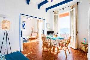 a dining room with a table and chairs in a room at MAIOUN Villefranche-sur-Mer AP4121 in Villefranche-sur-Mer