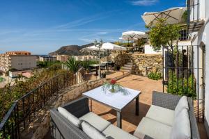 a patio with a table and chairs on a balcony at La Tartana Hotel Boutique in La Herradura