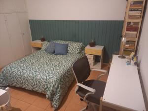 a bedroom with a bed and a table and a desk at Crespo Urbano in Buenos Aires