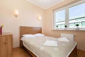 Posteľ alebo postele v izbe v ubytovaní Rezydencja Spacerowa Apartamenty by Noclegi Renters