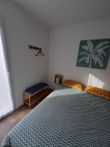 a bedroom with a bed with a blue comforter at Dune Blanche 300 m de l'Océan, appartement neuf 6 personnes in Seignosse