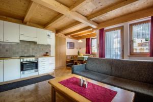 a living room with a couch and a table at Apartments Tino in La Valle