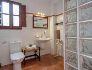 a bathroom with a toilet and a sink at La Tartana Hotel Boutique in La Herradura