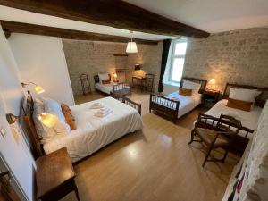 a bedroom with a bed and a living room at La Ferme Delaunay in Saint-Côme-du-Mont
