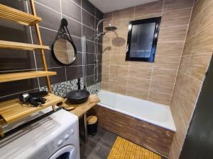 a small bathroom with a bath tub and a stove at Maison campagne 4 pers, terrasse et jardin, proche sentiers et thermes. - FR-1-589-418 in Harsault +24 photos