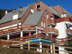 a large building with a sign in front of it at Appartement Le Pleynet, 1 pièce, 3 personnes - FR-1-557A-51 in La Ferrière