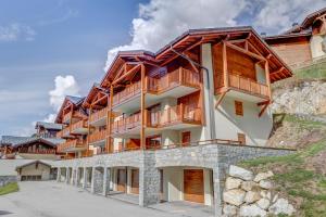 a building on the side of a mountain at Chalet des Oursons in Cohennoz