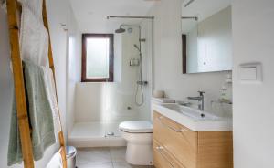 a bathroom with a toilet and a sink and a shower at La Tartana Hotel Boutique in La Herradura