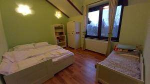 a bedroom with a large bed and a large window at Breaza - Grădina Ascunsa in Breaza