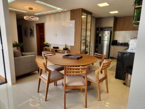 a kitchen and dining room with a wooden table and chairs at Casa em Alter Do Chão, com piscina, próxima a praia. in Santarém