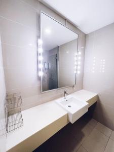 a bathroom with a sink and a large mirror at PROMO Connected train 1 Bedroom ABOVE MALL 3a in Kuala Lumpur