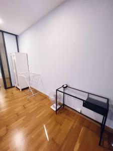 a white room with a bed and a wooden floor at PROMO Connected train 1 Bedroom ABOVE MALL 3a in Kuala Lumpur