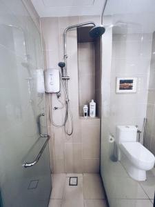 een badkamer met een douche en een toilet bij PROMO Connected train 1 Bedroom ABOVE MALL 3a in Kuala Lumpur