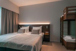 a bedroom with a large bed with two pillows at Original Sokos Hotel Seurahuone Savonlinna in Savonlinna