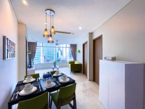 a kitchen and living room with a table and chairs at Vortex suites klcc by Surat in Kuala Lumpur