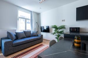 a living room with a couch and a table at Smartflats - Rogier Brussels in Brussels
