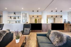 a living room with two couches and a bar at Plaza Regency Hotels in Sliema