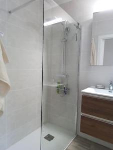 a shower with a glass door in a bathroom at Kalle Blanca - Cabo Roig in Cabo Roig