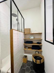 a bathroom with a staircase with a basket on the floor at Joli Appartement à 15min des Champs Elysée in Saint-Ouen
