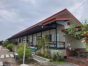 a house with a lot of plants in front of it at Sailom Resort​ in Chom Thong