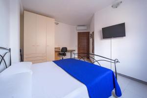 ラ・マッダレーナにあるIsola Che Non C'é Trilocale Casa Vacanze 80 mq con Terrazza La Maddalena Sardegnaのベッドルーム1室(青い毛布付きのベッド1台付)